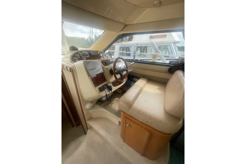 Slide: The Image of Interior of a 2004 Meridian 341 Sedan yacht, featuring a steering wheel and dashboard controls. - 28