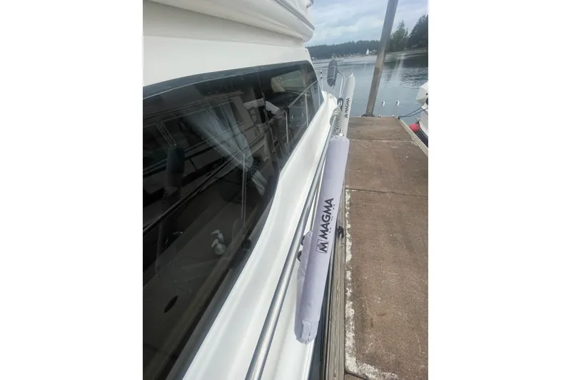 Slide: The Image of 2004 Meridian 341 Sedan yacht docked, featuring Magma grill cover on railing. - 30