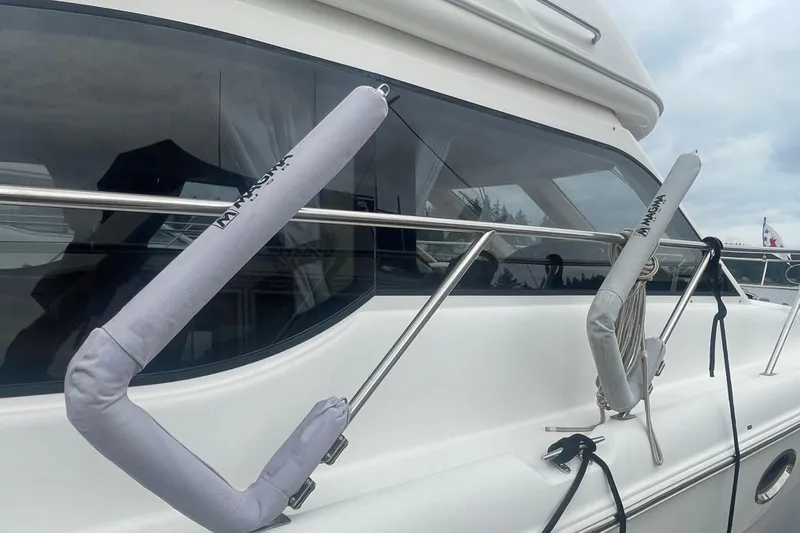 Slide: The Image of 2004 Meridian 341 Sedan yacht with protective rail covers and sleek windows. - 31