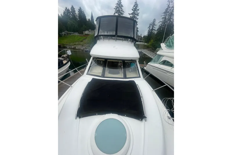 Slide: The Image of 2004 Meridian 341 Sedan yacht docked near lush forested shoreline. - 35