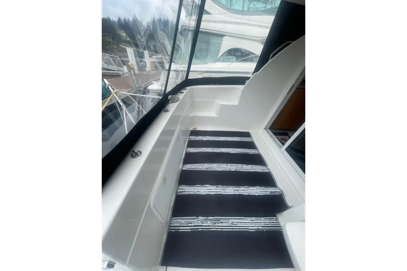 Slide: The Image of 2004 Meridian 341 Sedan boat interior with striped carpet and dockside view. - 4