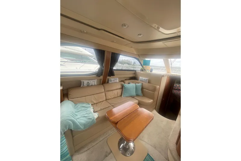 Slide: The Image of Luxurious interior of a 2004 Meridian 341 Sedan yacht with cozy seating and decor. - 9