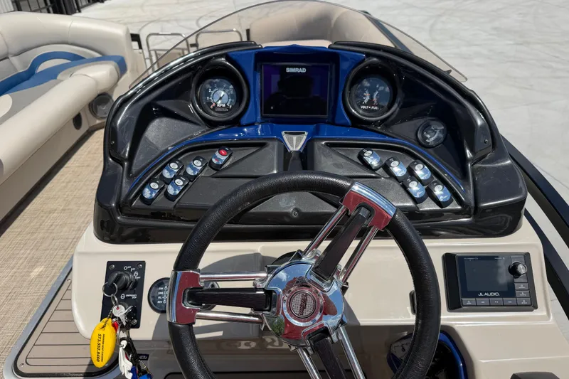 Slide: The Image of Steering console of a 2018 JC 25 Neptoon DSL pontoon boat with gauges and controls. - 15
