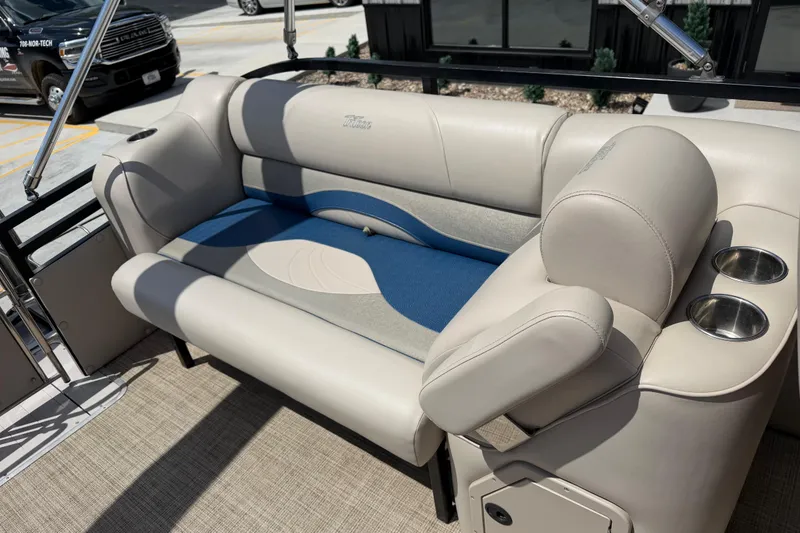 Slide: The Image of 2018 JC 25 Neptoon DSL boat interior with beige seating and cup holders. - 21