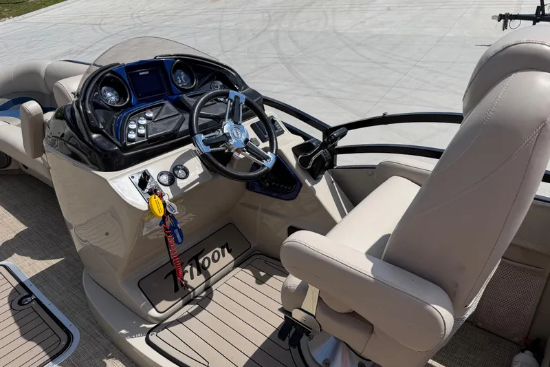 Slide: The Image of Cockpit of 2018 JC 25 Neptoon DSL pontoon boat with steering wheel and controls. - 23