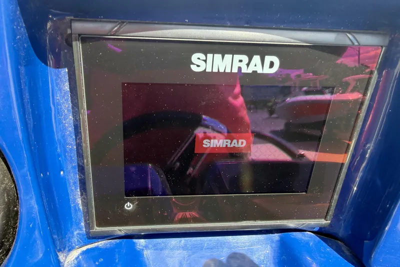 Slide: The Image of Simrad display on 2018 JC 25 Neptoon DSL boat dashboard, reflecting surroundings. - 31