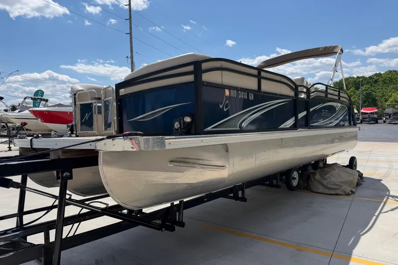 Slide: The Image of 2018 JC 25 Neptoon DSL pontoon boat on trailer under clear blue sky. - 8