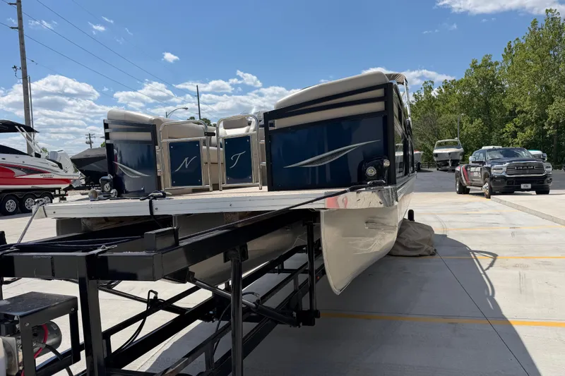 Slide: The Image of 2018 JC 25 Neptoon DSL pontoon boat on trailer in sunny outdoor setting. - 9