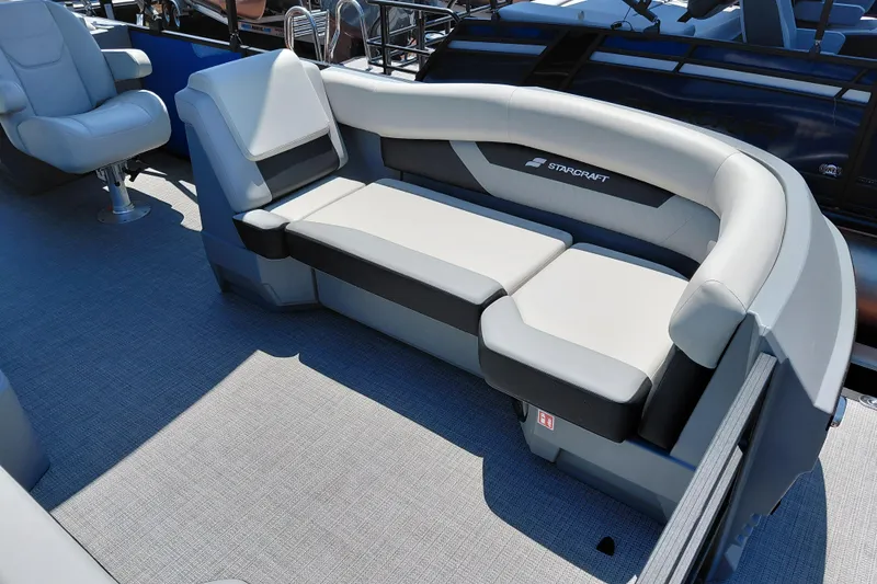 Slide: The Image of 2026 Starcraft VX 22 R DH pontoon boat interior with plush seating and modern design. - 12