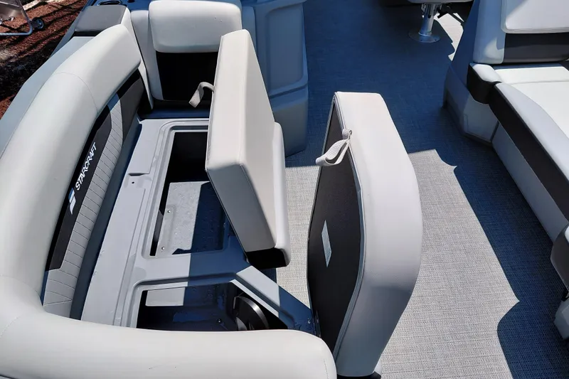 Slide: The Image of 2026 Starcraft VX 22 R DH boat interior with open storage compartment and cushioned seating. - 20