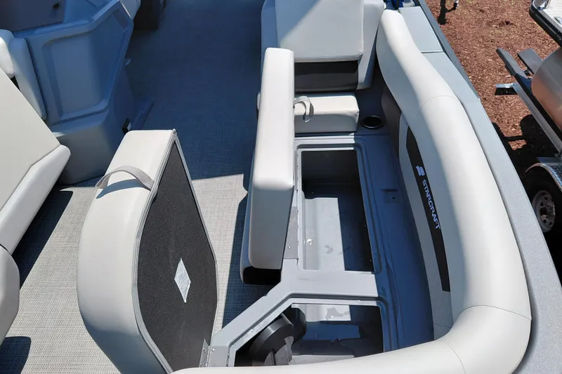 Slide: The Image of 2026 Starcraft VX 22 R DH boat interior with open storage compartment and cushioned seating. - 21