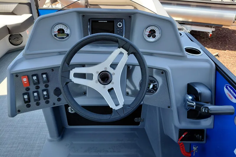 Slide: The Image of 2026 Starcraft VX 22 R DH boat dashboard with steering wheel and control panel. - 25