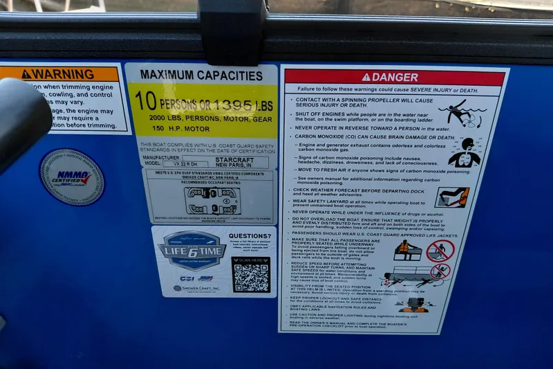 Slide: The Image of Safety and capacity labels on a 2026 Starcraft VX 22 R DH boat. - 26