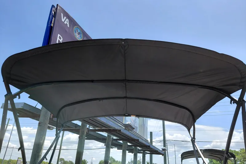 Slide: The Image of 2026 Starcraft VX 22 R DH boat canopy under clear blue sky. - 29
