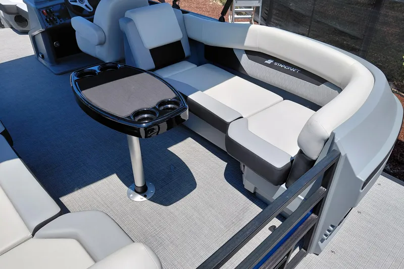 Slide: The Image of 2026 Starcraft VX 22 R DH pontoon boat interior with plush seating and sleek table design. - 32