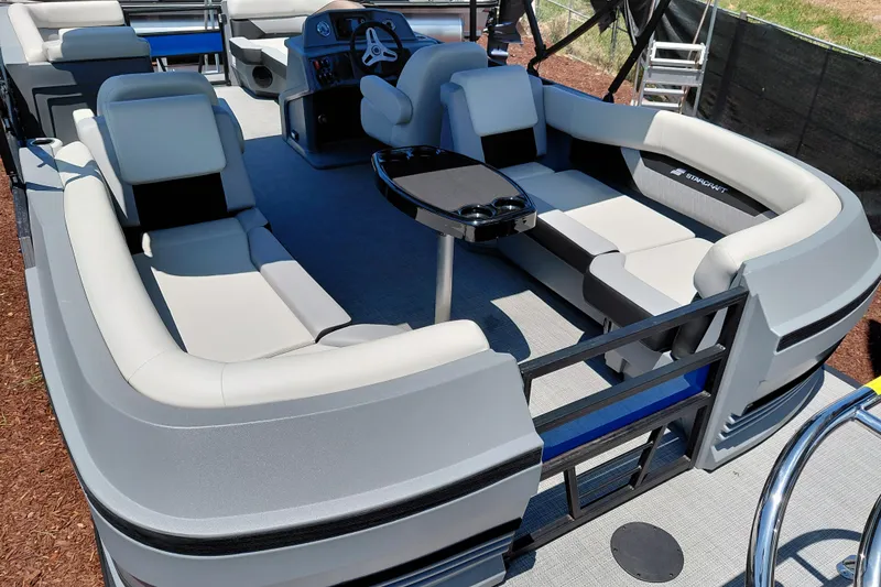 Slide: The Image of 2026 Starcraft VX 22 R DH pontoon boat interior with plush seating and steering console. - 38