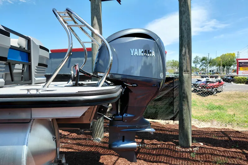 Slide: The Image of 2026 Starcraft VX 22 R DH boat with Yamaha outboard motor, parked outdoors. - 5