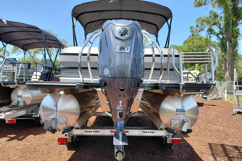 Slide: The Image of 2026 Starcraft VX 22 R DH pontoon boat with powerful outboard motor, displayed on trailer. - 6