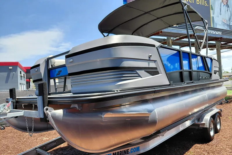 Slide: The Image of 2026 Starcraft VX 22 R DH pontoon boat on trailer, featuring sleek design and canopy. - 8