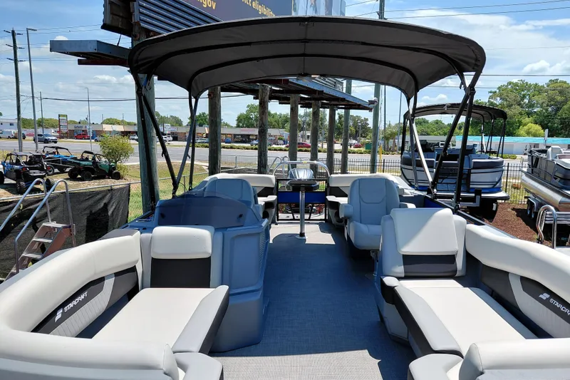 Slide: The Image of 2026 Starcraft VX 22 R DH pontoon boat with spacious seating and canopy, displayed outdoors. - 9