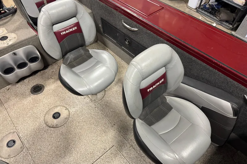 Slide: The Image of Interior of a 2011 Tracker Targa V-18 Combo boat with two gray seats. - 10