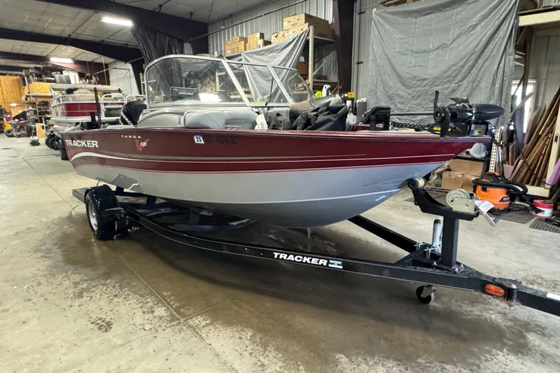 Slide: The Image of 2011 Tracker Targa V-18 Combo boat on trailer in indoor storage facility. - 2