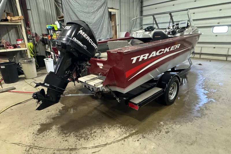 Slide: The Image of 2011 Tracker Targa V-18 Combo boat with Mercury engine in a garage setting. - 3