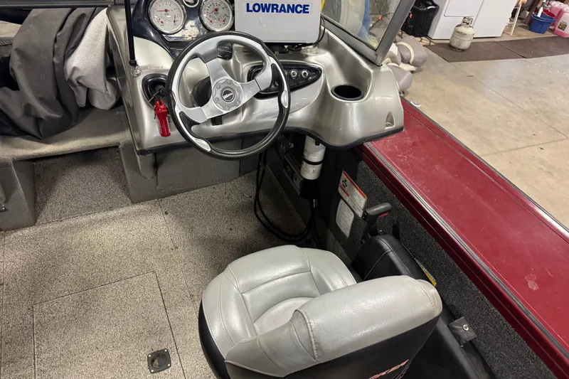 Slide: The Image of 2011 Tracker Targa V-18 Combo boat cockpit with steering wheel and Lowrance display. - 6
