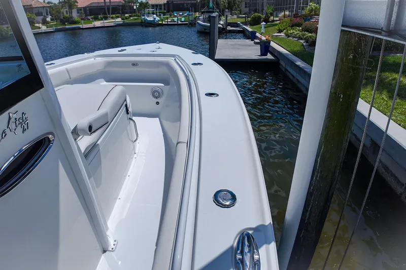Slide: The Image of 2022 Sea Hunt Gamefish 27 boat docked in a scenic marina setting. - 11