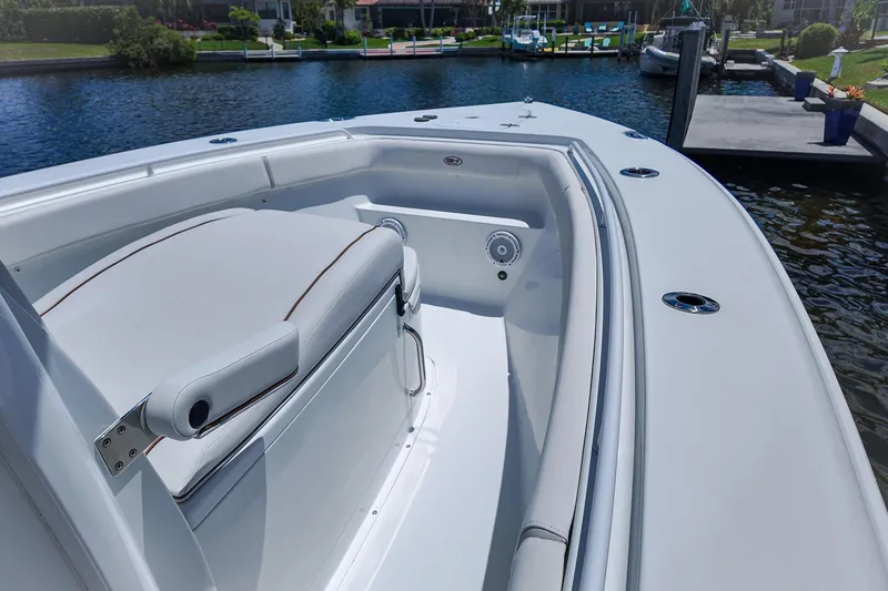 Slide: The Image of 2022 Sea Hunt Gamefish 27 boat interior with cushioned seating and water view. - 12