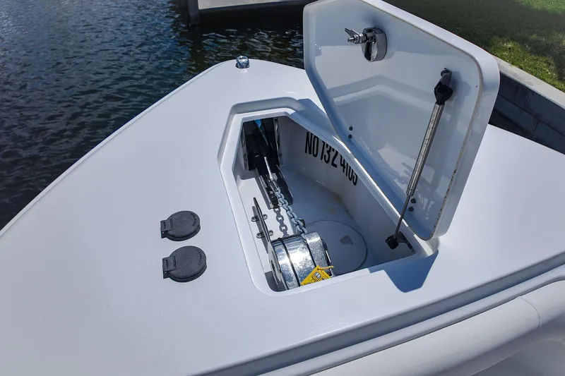 Slide: The Image of 2022 Sea Hunt Gamefish 27 anchor compartment with open hatch, dockside view. - 14