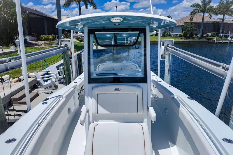 Slide: The Image of 2022 Sea Hunt Gamefish 27 boat docked by a scenic waterfront. - 15