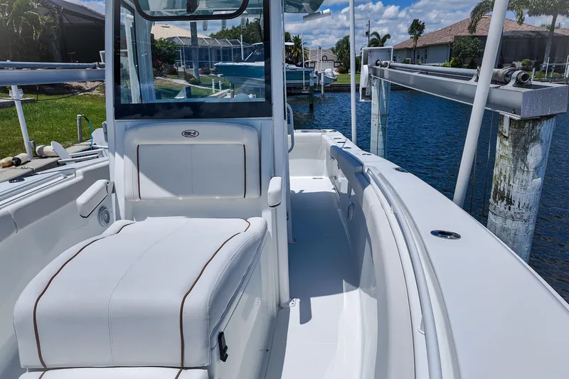 Slide: The Image of 2022 Sea Hunt Gamefish 27 boat interior, featuring sleek seating and modern design by the water. - 16