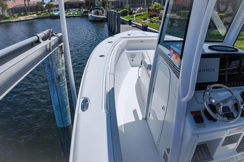 Slide: The Image of 2022 Sea Hunt Gamefish 27 boat docked, featuring sleek design and modern navigation equipment. - 17