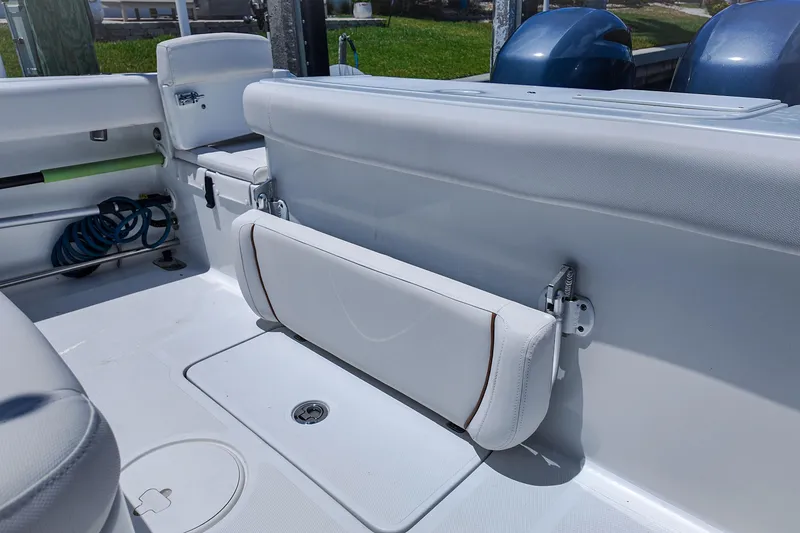 Slide: The Image of 2022 Sea Hunt Gamefish 27 boat interior with foldable seating and storage area. - 18