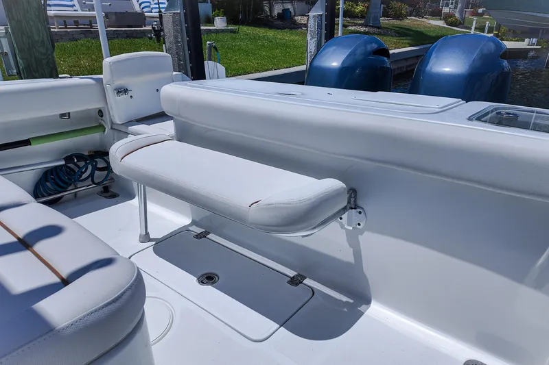 Slide: The Image of 2022 Sea Hunt Gamefish 27 boat interior with seating and dual outboard motors. - 19