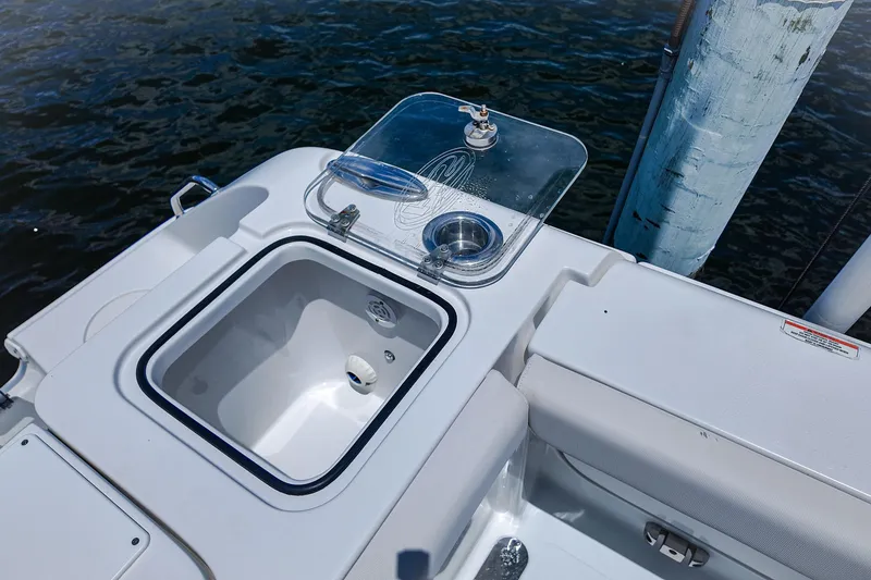 Slide: The Image of 2022 Sea Hunt Gamefish 27 boat with open storage compartment and water view. - 21
