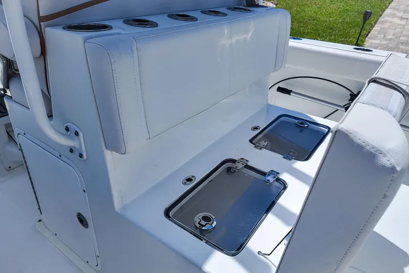 Slide: The Image of 2022 Sea Hunt Gamefish 27 boat seating with storage compartments and cup holders. - 23