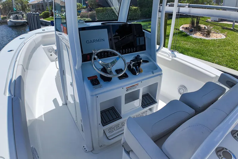 Slide: The Image of 2022 Sea Hunt Gamefish 27 boat cockpit with Garmin navigation system and dual seating. - 25
