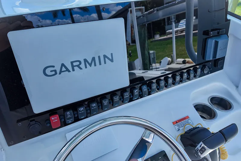 Slide: The Image of 2022 Sea Hunt Gamefish 27 dashboard with Garmin navigation system and control panel. - 26