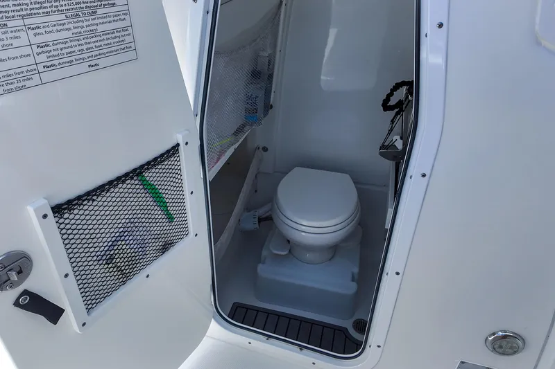 Slide: The Image of 2022 Sea Hunt Gamefish 27 boat interior with compact marine toilet. - 29