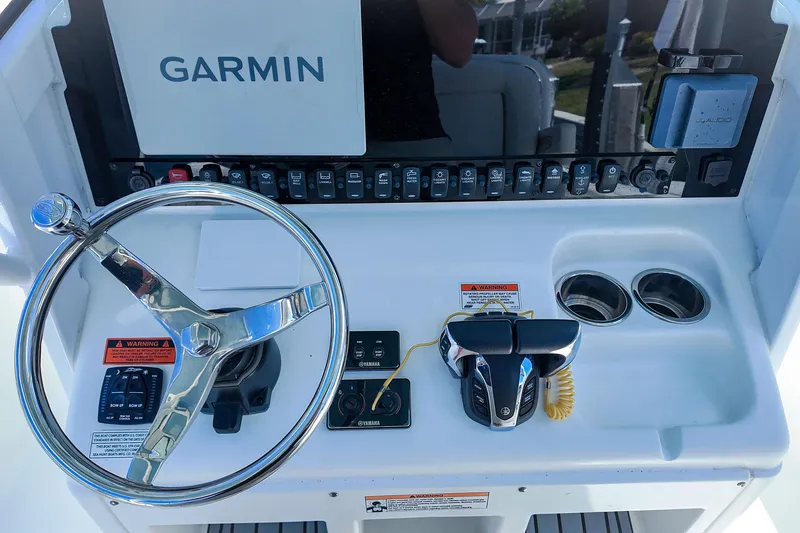 Slide: The Image of Steering console of 2022 Sea Hunt Gamefish 27 with Garmin display and controls. - 24