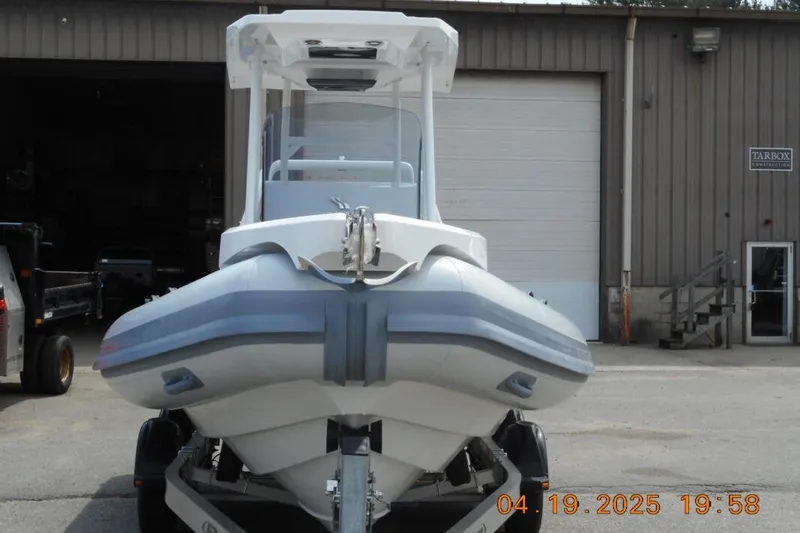 The Image of Highfield Sport 760 boat 2025 in front of warehouse. - 1