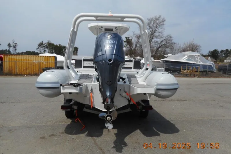 Slide: The Image of Highfield Sport 760 boat, 2025 model, rear view with powerful outboard motor. - 4