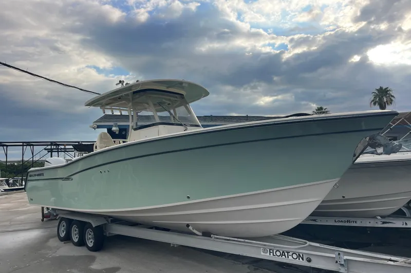 The Image of 2018 Grady-White Canyon 306 boat on trailer under cloudy sky. - 0