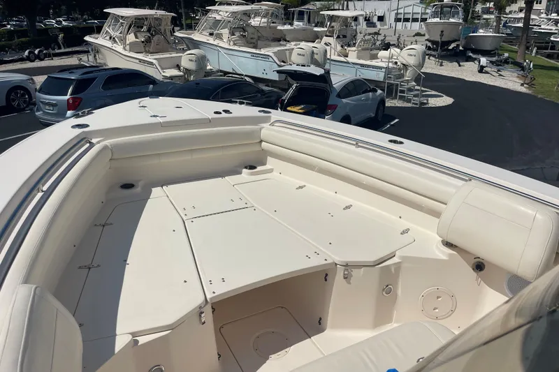 Slide: The Image of 2018 Grady-White Canyon 306 boat interior with seating, parked among other boats. - 10