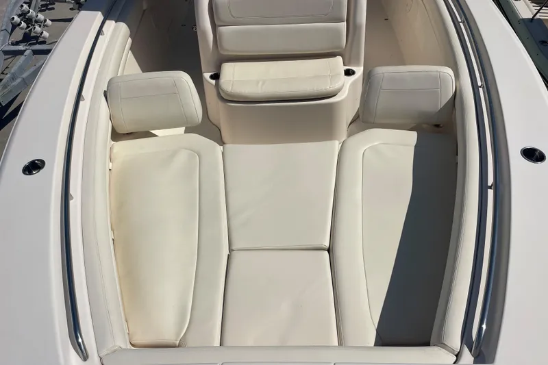 Slide: The Image of 2018 Grady-White Canyon 306 boat interior with white cushioned seating. - 12