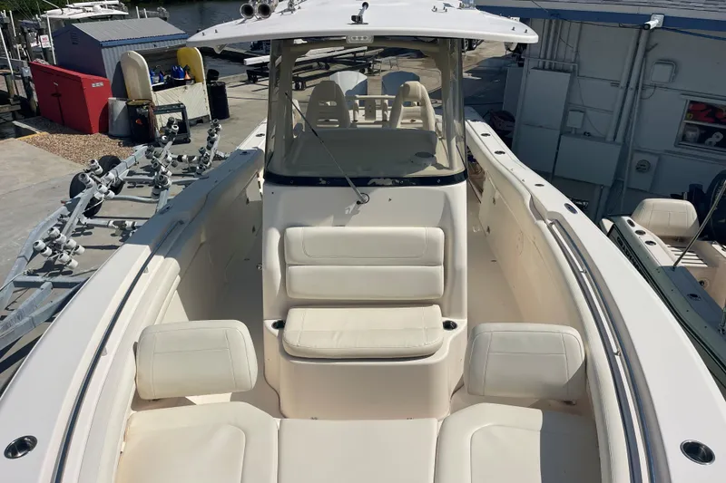 Slide: The Image of 2018 Grady-White Canyon 306 boat interior with white seating and helm station. - 13