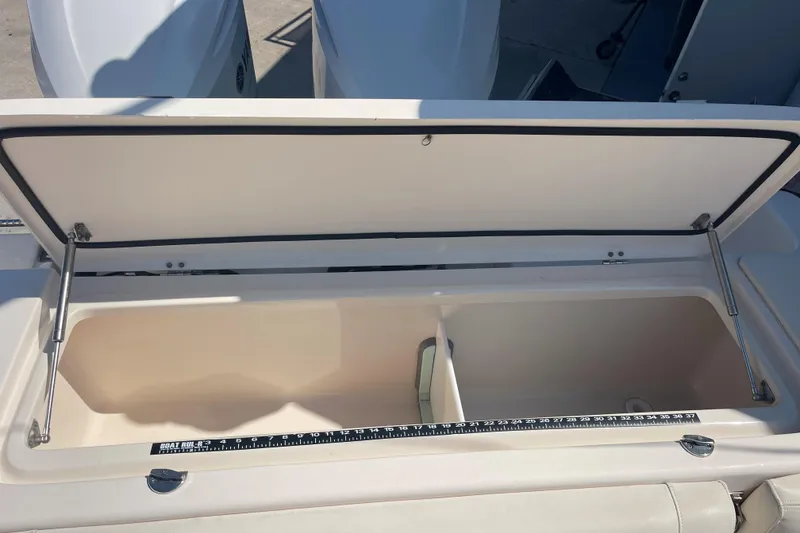 Slide: The Image of Open storage compartment on 2018 Grady-White Canyon 306 boat with measuring ruler. - 15