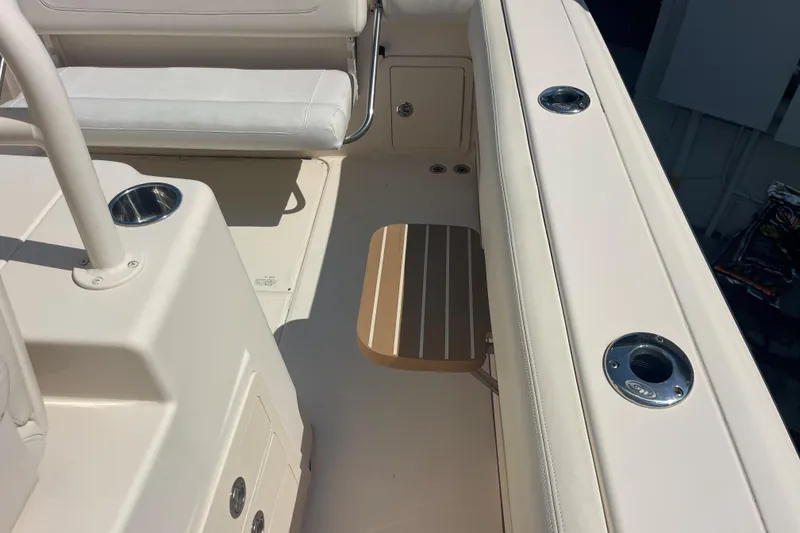 Slide: The Image of Interior of 2018 Grady-White Canyon 306 boat, featuring seating and cup holders. - 17